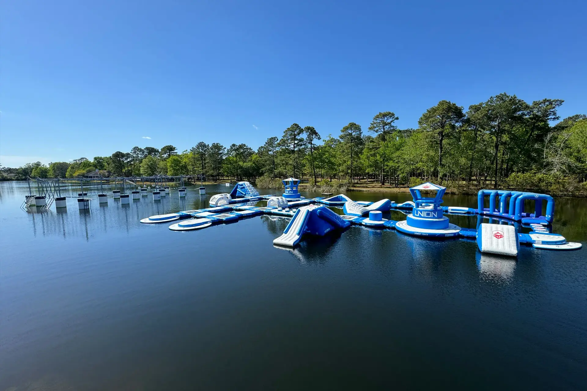 Guests having fun on floating obstacle course at Charleston Aqua Park water adventure park